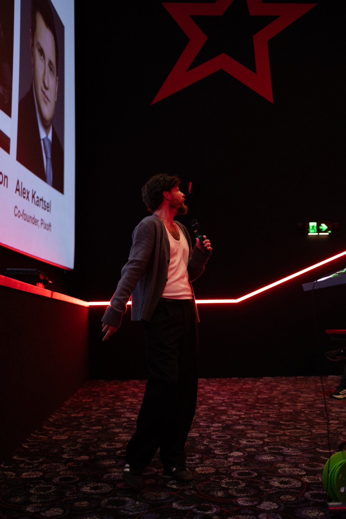 A student founder pitching on stage at StudentVenture's Pitch at the Movies, Cineworld